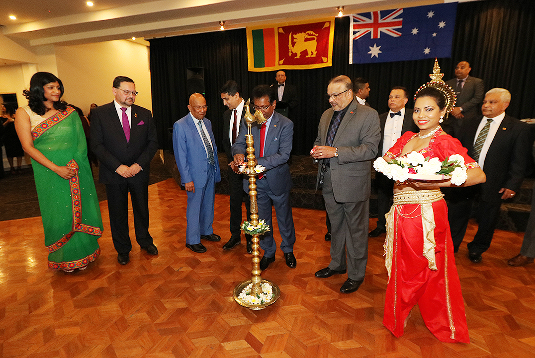 High Commissioner Weliamuna lighting the traditional oil lamp while Victorian Parliamentarians Craig Ondarchie & Dr Samantha Ratnam looks on at the opening of the welcome reception